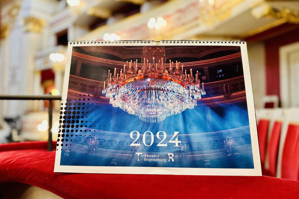 Verschenken Sie mit unserem Theaterkalender 2024 (Format A3) mit 12 ausdrucksstarken Produktionsbildern ein Stück Theater Regensburg für daheim. 